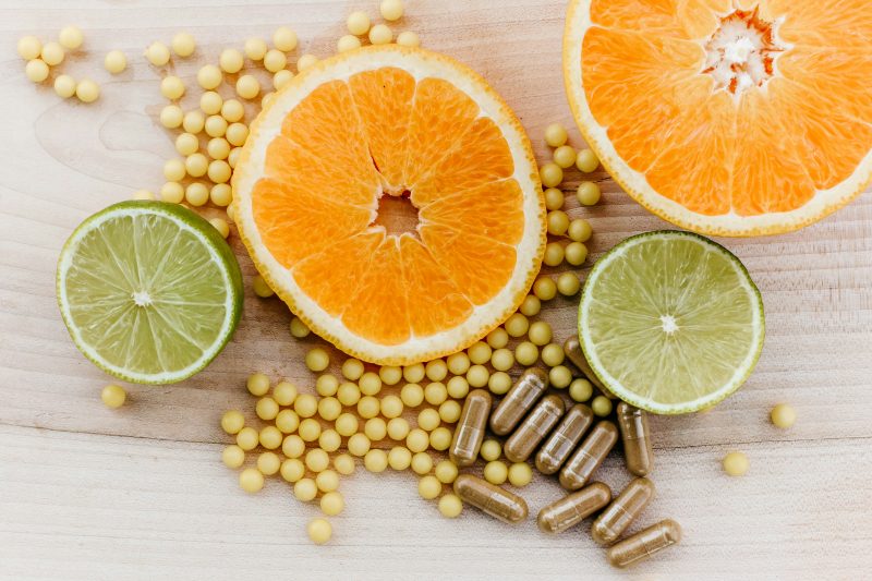 oranges peas and limes on a wooden table for homeopathy at trinity natural health frankfurt